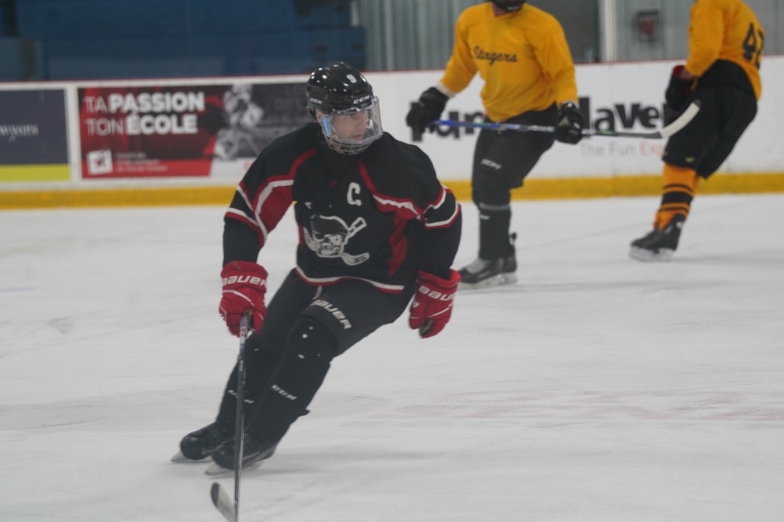 An OARHL captain skating with a full face shield